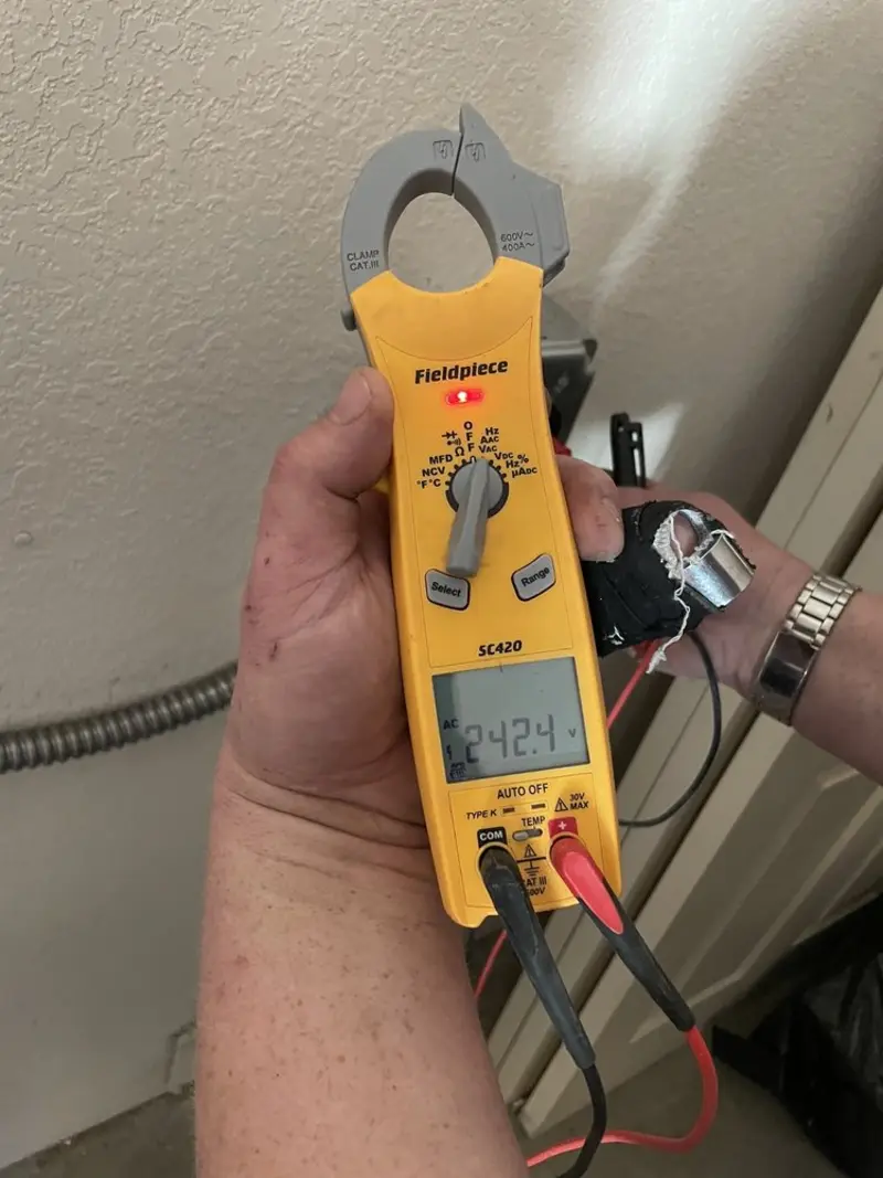 Voltage testing with clamp meter during Electrical Installation Services in Winterville